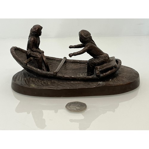 228 - Cast bronze of two oriental figures in a rowing boat as found without the oars. 19 cm x 11 cm x 9 cm... 