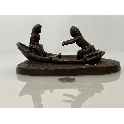 228 - Cast bronze of two oriental figures in a rowing boat as found without the oars. 19 cm x 11 cm x 9 cm... 