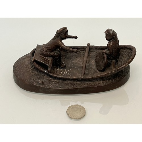 228 - Cast bronze of two oriental figures in a rowing boat as found without the oars. 19 cm x 11 cm x 9 cm... 