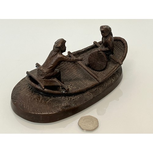 228 - Cast bronze of two oriental figures in a rowing boat as found without the oars. 19 cm x 11 cm x 9 cm... 