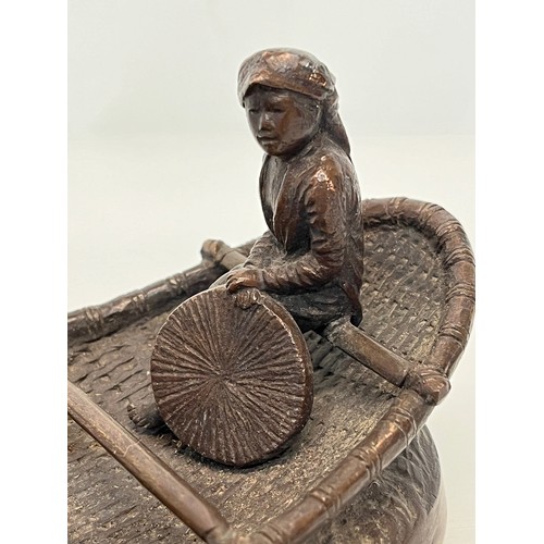 228 - Cast bronze of two oriental figures in a rowing boat as found without the oars. 19 cm x 11 cm x 9 cm... 