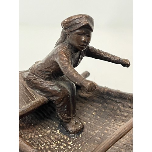 228 - Cast bronze of two oriental figures in a rowing boat as found without the oars. 19 cm x 11 cm x 9 cm... 