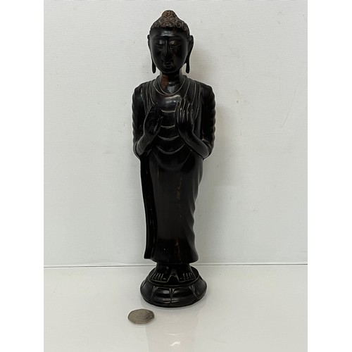 231 - A hand carved hardwood Buddist figure. 31 cm tall.

This lot is available for in-house shipping