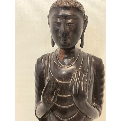 231 - A hand carved hardwood Buddist figure. 31 cm tall.

This lot is available for in-house shipping