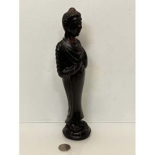 231 - A hand carved hardwood Buddist figure. 31 cm tall.

This lot is available for in-house shipping