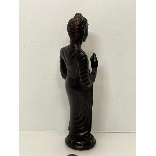 231 - A hand carved hardwood Buddist figure. 31 cm tall.

This lot is available for in-house shipping