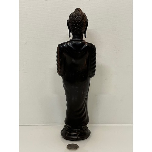 231 - A hand carved hardwood Buddist figure. 31 cm tall.

This lot is available for in-house shipping