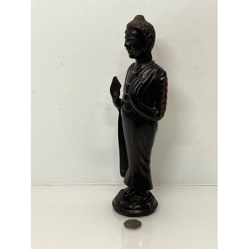 231 - A hand carved hardwood Buddist figure. 31 cm tall.

This lot is available for in-house shipping