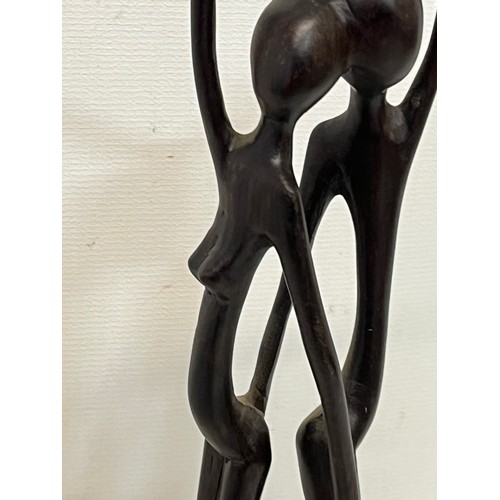 232 - A hand carved hard wood African sculpture of a couple.

This lot is available for in-house shipping