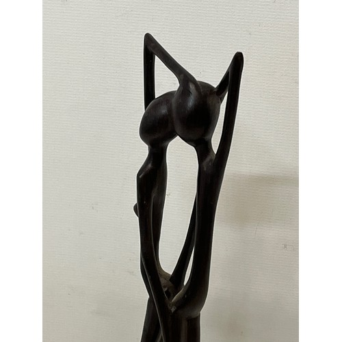 232 - A hand carved hard wood African sculpture of a couple.

This lot is available for in-house shipping