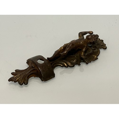 233 - A pair of cast furniture embellishments with cast in Cherub figures, each is 18 cm long.

This lot i... 