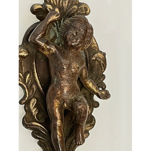 233 - A pair of cast furniture embellishments with cast in Cherub figures, each is 18 cm long.

This lot i... 