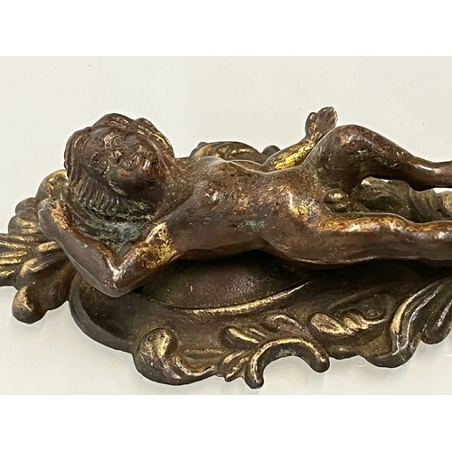 233 - A pair of cast furniture embellishments with cast in Cherub figures, each is 18 cm long.

This lot i... 