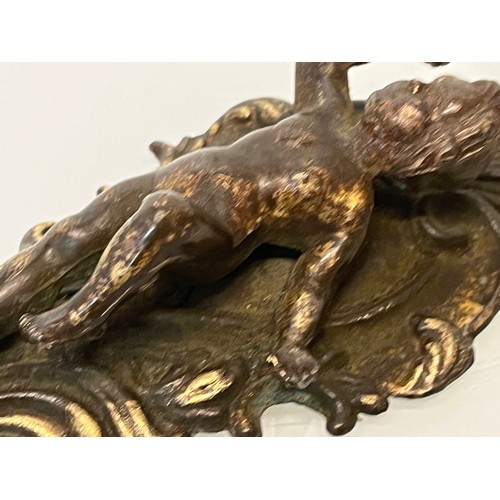 233 - A pair of cast furniture embellishments with cast in Cherub figures, each is 18 cm long.

This lot i... 