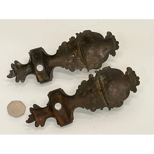 233 - A pair of cast furniture embellishments with cast in Cherub figures, each is 18 cm long.

This lot i... 