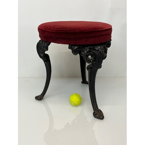 235 - A Victorian upholstered stool with cast iron legs, 43 cm high and 34 cm in diameter.

This lot is co... 