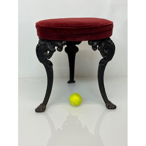 235 - A Victorian upholstered stool with cast iron legs, 43 cm high and 34 cm in diameter.

This lot is co... 