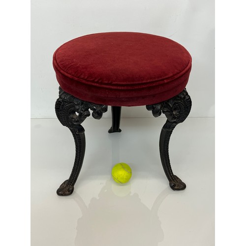 235 - A Victorian upholstered stool with cast iron legs, 43 cm high and 34 cm in diameter.

This lot is co... 