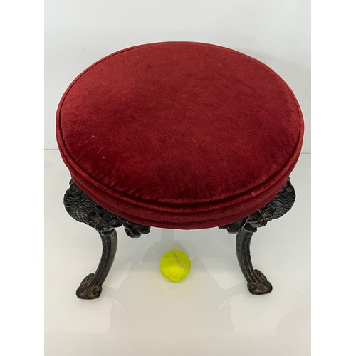 235 - A Victorian upholstered stool with cast iron legs, 43 cm high and 34 cm in diameter.

This lot is co... 