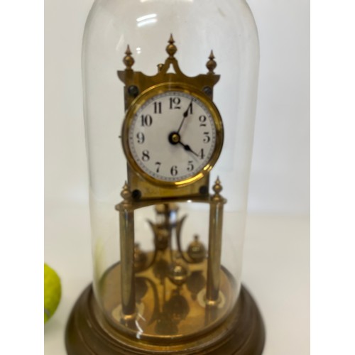 353 - Brass mantle clock in a domed glass cover.

This lot is available for in-house shipping