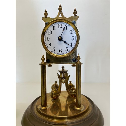 353 - Brass mantle clock in a domed glass cover.

This lot is available for in-house shipping