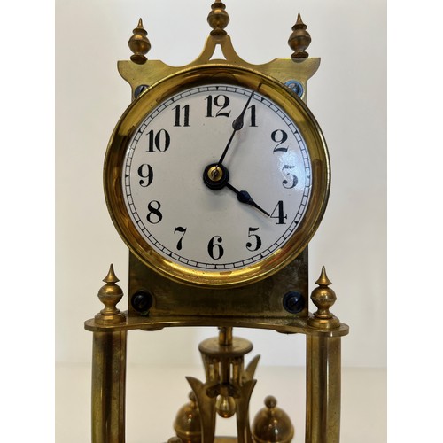 353 - Brass mantle clock in a domed glass cover.

This lot is available for in-house shipping