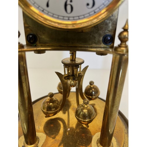 353 - Brass mantle clock in a domed glass cover.

This lot is available for in-house shipping