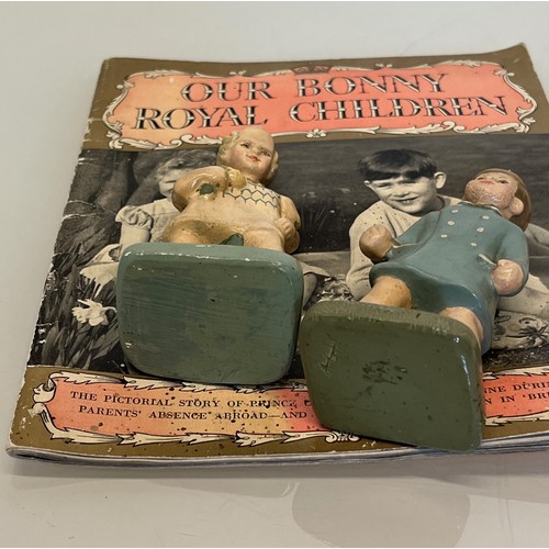 358 - Pair of figurines of Prince  Charles and Princess Anne a book on the Royal Children.

This lot is av... 