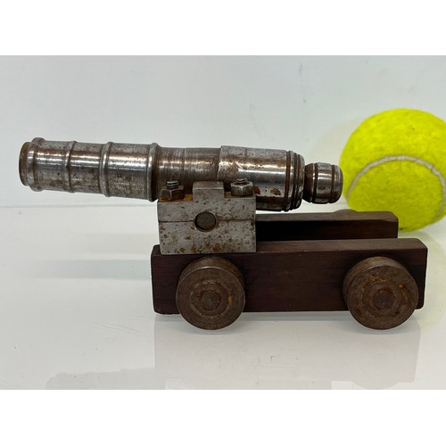 375 - Model cannon, with a turned barrel on a wooden carrage.

This lot is available for in-house shipping... 