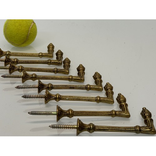 264 - Decorative fittings, eight brass classically designed tie backs, 10 cm long when mounted.

This lot ... 