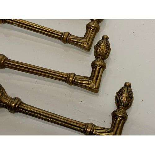 264 - Decorative fittings, eight brass classically designed tie backs, 10 cm long when mounted.

This lot ... 