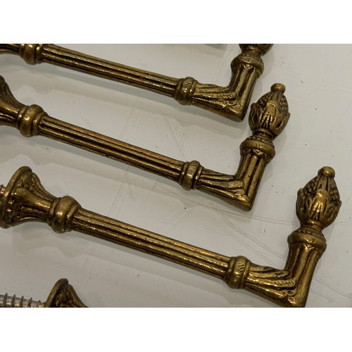 264 - Decorative fittings, eight brass classically designed tie backs, 10 cm long when mounted.

This lot ... 