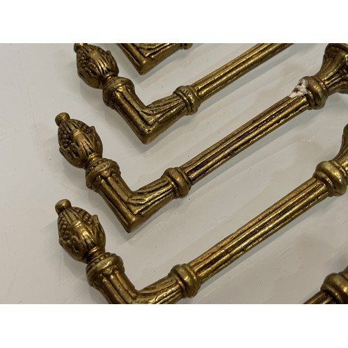 264 - Decorative fittings, eight brass classically designed tie backs, 10 cm long when mounted.

This lot ... 