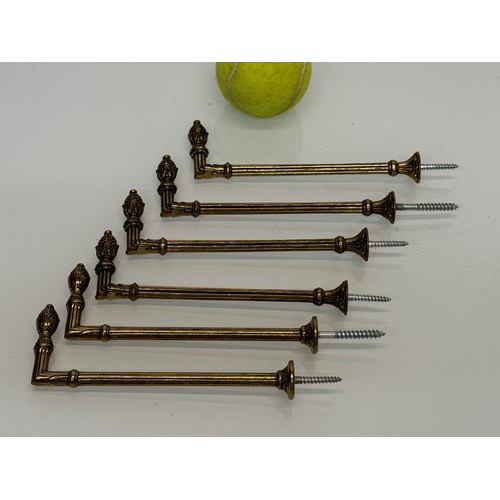 265 - Decorative fittings, six brass classical design tie backs, 15 cm long when mounted.

This lot is ava... 