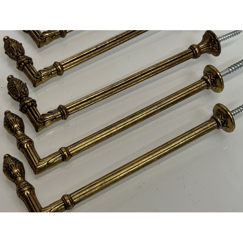 265 - Decorative fittings, six brass classical design tie backs, 15 cm long when mounted.

This lot is ava... 