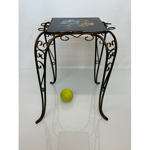 67 - Furniture, a kitsch tiled top wrought iron side table.

This lot is available for in-house shipping