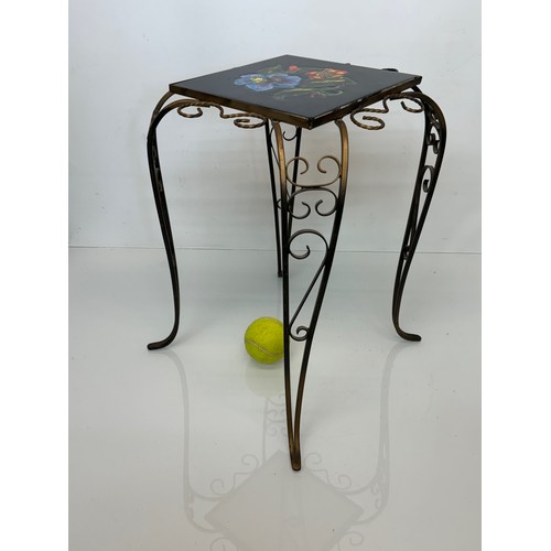 67 - Furniture, a kitsch tiled top wrought iron side table.

This lot is available for in-house shipping