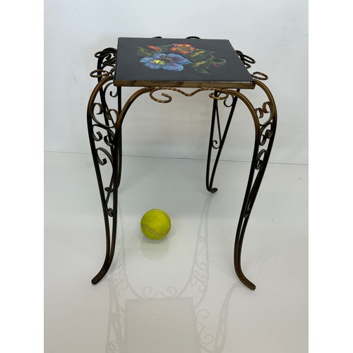 67 - Furniture, a kitsch tiled top wrought iron side table.

This lot is available for in-house shipping