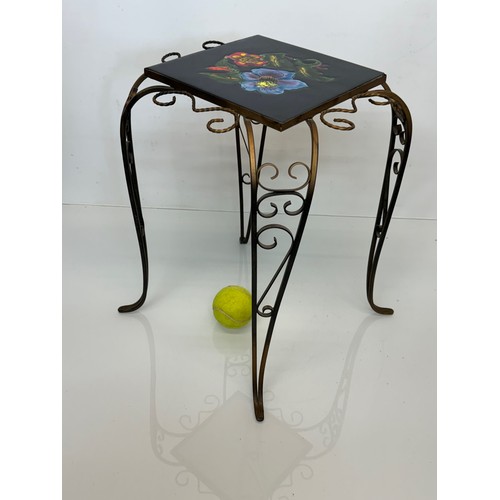 67 - Furniture, a kitsch tiled top wrought iron side table.

This lot is available for in-house shipping