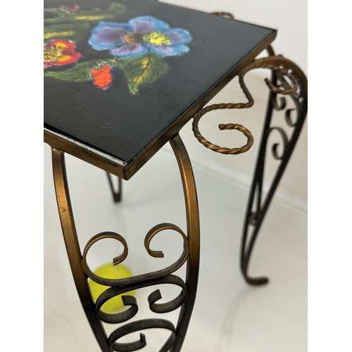 67 - Furniture, a kitsch tiled top wrought iron side table.

This lot is available for in-house shipping