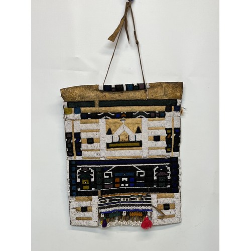 3 - Tribal art, a hide apron with beadwork decoration. 49 cm x 40 cm.

This lot is available for in-hous... 