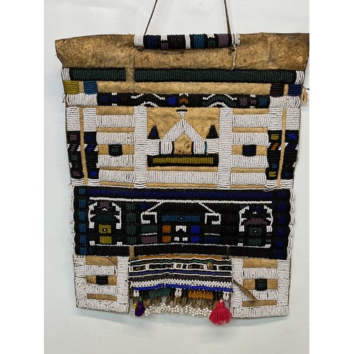 3 - Tribal art, a hide apron with beadwork decoration. 49 cm x 40 cm.

This lot is available for in-hous... 