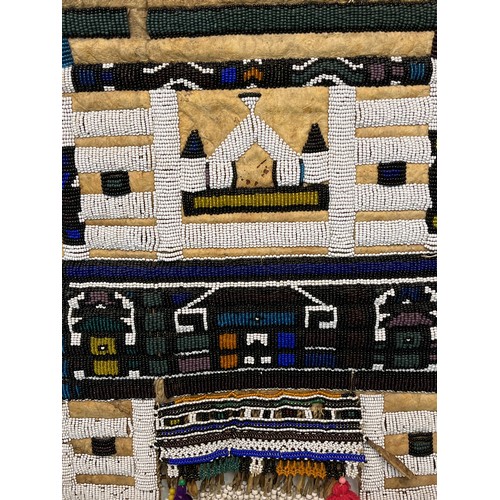 3 - Tribal art, a hide apron with beadwork decoration. 49 cm x 40 cm.

This lot is available for in-hous... 