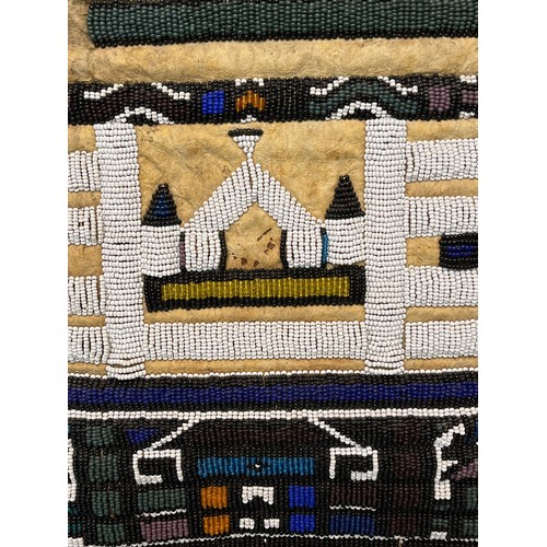 3 - Tribal art, a hide apron with beadwork decoration. 49 cm x 40 cm.

This lot is available for in-hous... 