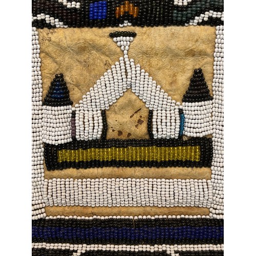 3 - Tribal art, a hide apron with beadwork decoration. 49 cm x 40 cm.

This lot is available for in-hous... 