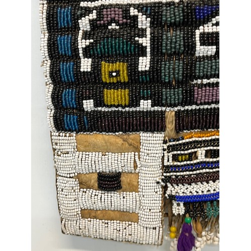 3 - Tribal art, a hide apron with beadwork decoration. 49 cm x 40 cm.

This lot is available for in-hous... 