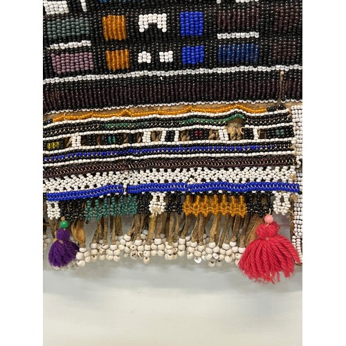 3 - Tribal art, a hide apron with beadwork decoration. 49 cm x 40 cm.

This lot is available for in-hous... 