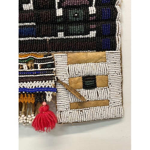 3 - Tribal art, a hide apron with beadwork decoration. 49 cm x 40 cm.

This lot is available for in-hous... 