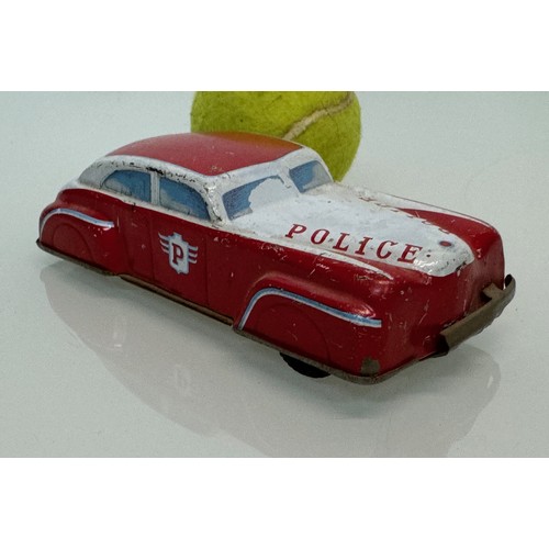 278 - Toys, automobilia, a vintage German US Zone tin plate police car with friction drive., 15 cm long.

... 