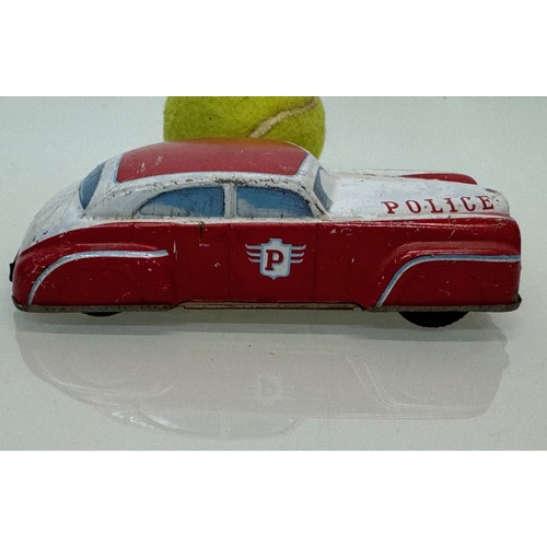 278 - Toys, automobilia, a vintage German US Zone tin plate police car with friction drive., 15 cm long.

... 